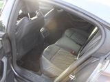the back seat of a car with a luggage bag in it