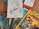 many children ' s books sitting on a wooden table