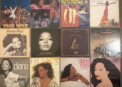 many different album covers on the wall of a room