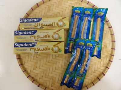 four toothbrushes sitting on a bamboo tray on a table