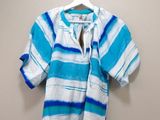 blue and white striped shirt hanging on a hanger on a wall