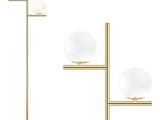 a gold floor lamp with two glass globes on a stand