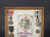 an old picture of a woman with medals and medals in a frame