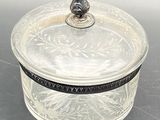 an antique silver plated box with a lid and a bird on top