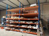 many shelves with rolls of paper on them in a warehouse