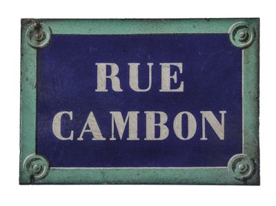 a blue and white sign that says rue cambon
