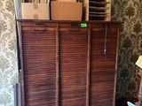 a wooden cabinet with many boxes on top of it