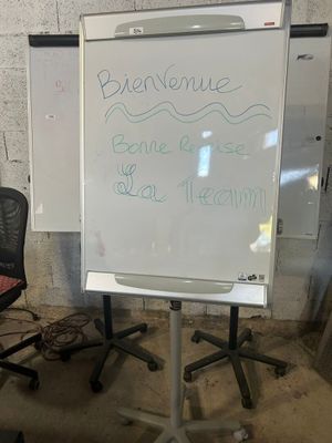 un tableau blanc sur lequel sont inscrits des mots, dans une pièce