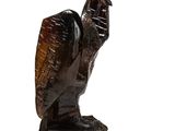 statue of an owl made of wood on a white background