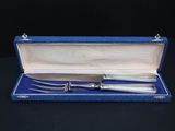 a silverware set in a blue case on a black table