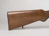 an old wooden rifle with a wooden barrel on a white background