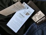 the back of a blue jacket with a tag attached to it