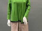 an image of a mannequin wearing a green top and pink shorts
