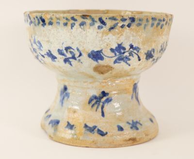 a blue and white bowl sitting on a white surface