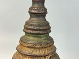 a small wooden bell with a bird on top of it