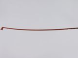 a close up of a person ' s hand holding a piece of copper wire