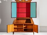 a cabinet with a mirror on top of it in a room
