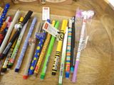 a lot of pens and pencils on the table