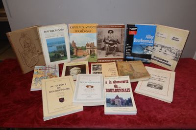 several books on a table with a red cloth on it