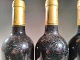 three bottles of wine that are sitting on a table