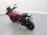 a red and black motorcycle parked in a room