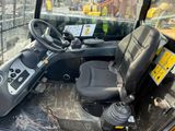 a close up of the driver ' s seat of a construction vehicle
