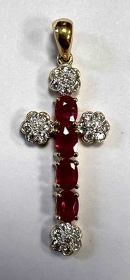 a close up of a red and white diamond cross on a white surface