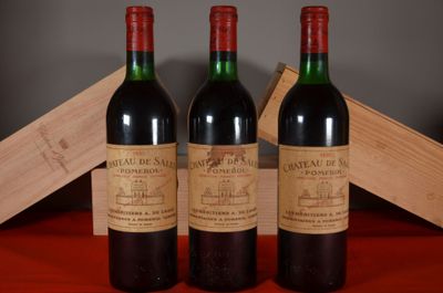three bottles of wine sitting on top of a table next to a wooden box