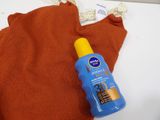 an image of a bottle of sun lotion sitting on top of a towel