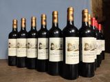 several bottles of wine are lined up in a row on a table