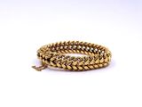 a close up of a gold chain bracelet on a white background