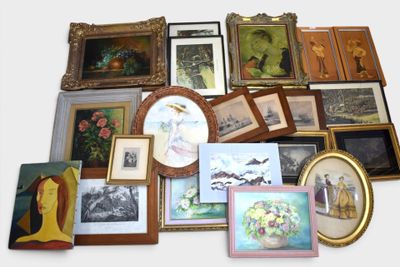 a lot of framed pictures and paintings on the wall