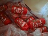 a bunch of soda bottles wrapped in plastic on top of a counter