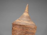 a large woven basket with a wooden lid on a grey background
