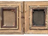 two wooden frames with a picture hanging on the wall