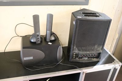 two speakers sitting on top of a table with a speaker on it