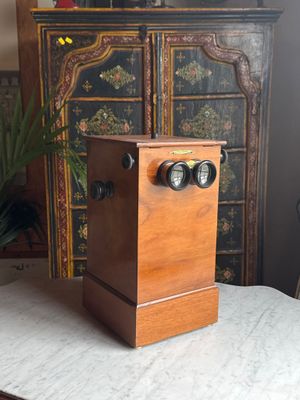 a small wooden box with two knobs on top of a table