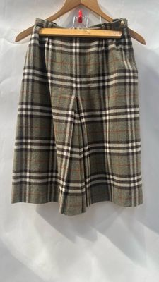 a close up of a skirt on a hanger on a white background