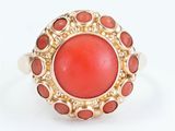 an image of a coral and gold ring on a white background