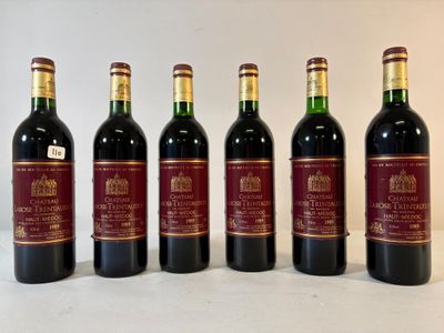 six bouteilles de vin sont alignées sur une table