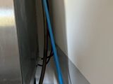a close up of a blue hose attached to a wall