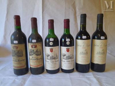 several bottles of wine are lined up on a table