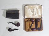 a box with a pipe, a wallet, and a pair of glasses