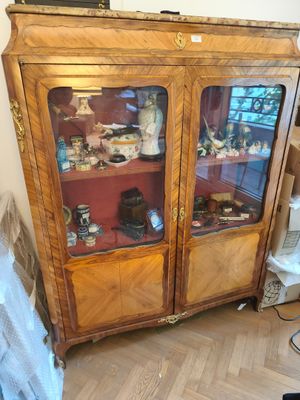 a wooden cabinet with glass doors in a room