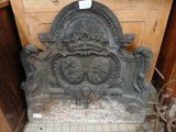 a stone fireplace with a crown on top of it