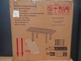 cardboard box sitting on top of a wooden table on a shelf