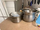 pots and pans are sitting on a counter in a kitchen