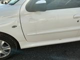 a white car that is parked in a parking lot