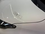 a close up of a car ' s hood with a sticker on it