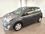 the small grey car is parked in a large room
